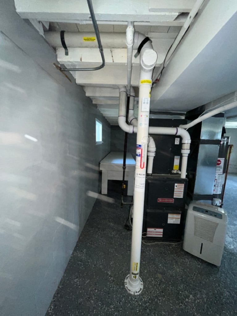 Radon mitigation system in residential basement installation