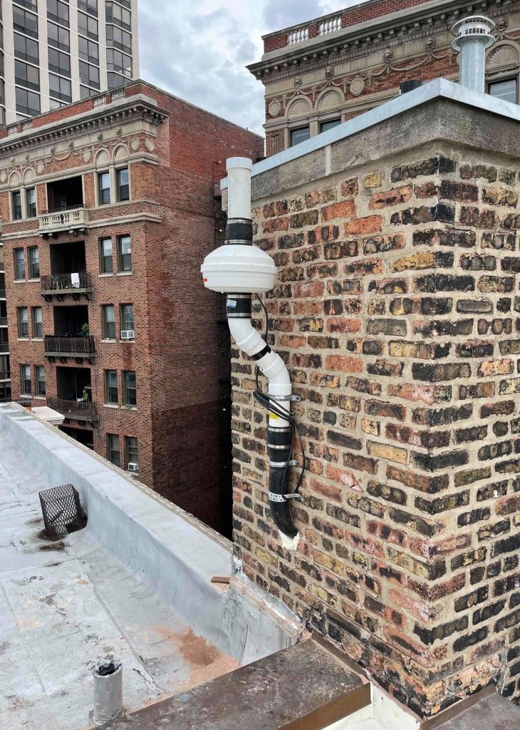 Commercial Radon Mitigation System on Brick Building Rooftop